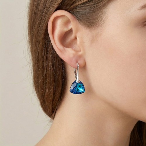 Kolczyk z kryształem Bermuda Blue prezentowany na uchu modelki